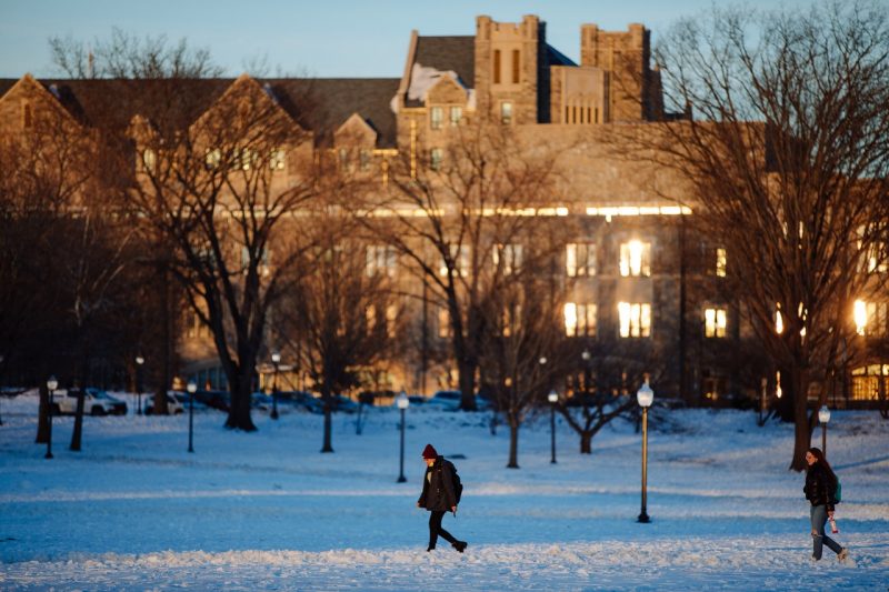 Students cross a snow-covered Drillfield in January 2022. 