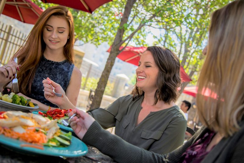 Campus dining patrons enjoy a plant-forward meal outside.