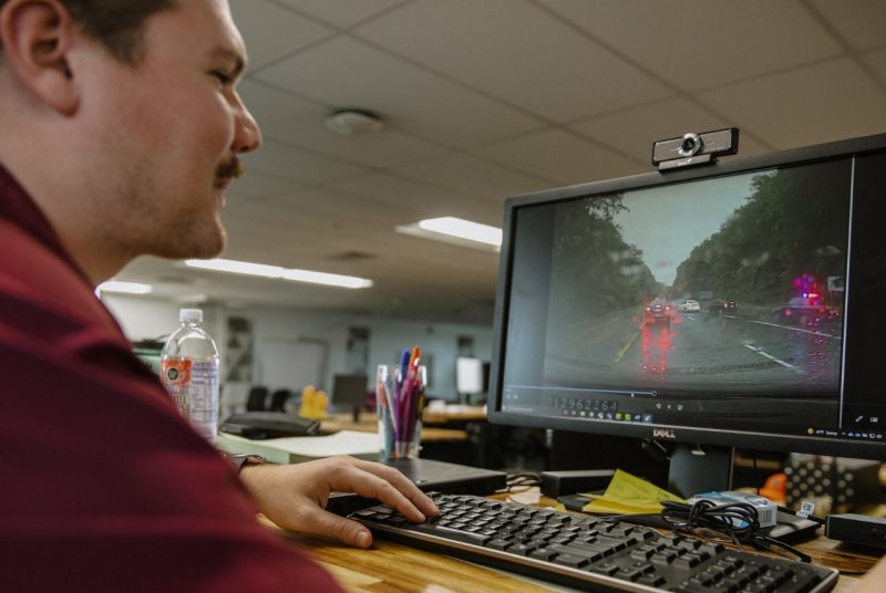 Jacob Valente, third year doctoral student in the Virginia Tech – Wake Forest University School of Biomedical Engineering and Sciences program, conducts research on a computer, analyzing images of cars driving.