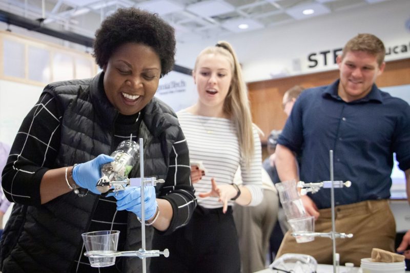 Brenda Brand, a professor of science education in the Virginia Tech School of Education, conducts a demonstration during a STEM fair for graduate students
