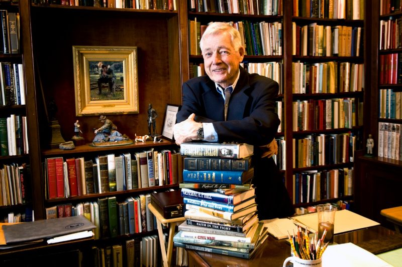 James I. “Bud” Robertson Jr. stands in his home study with a few of his published works in 2011. Photo by John McCormick for Virginia Tech.