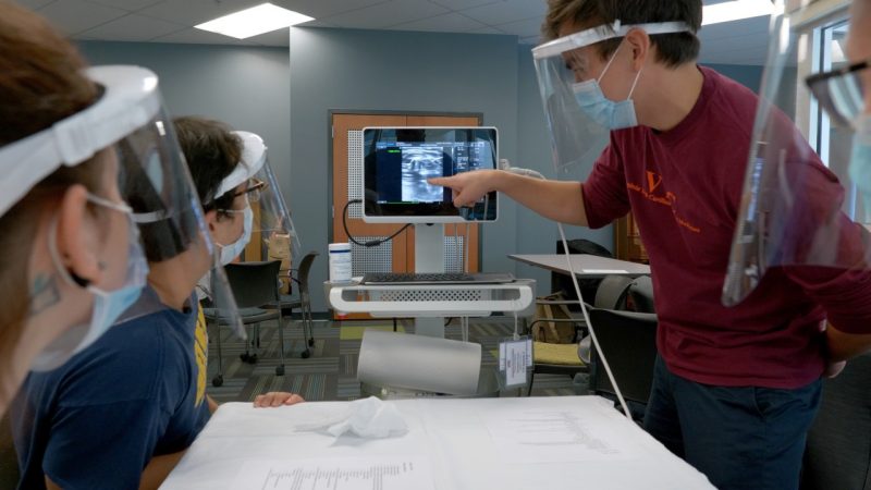 Students at the Virginia Tech Carilion School of Medicine work with a portable ultrasound machine. Photo by Ryan Anderson.