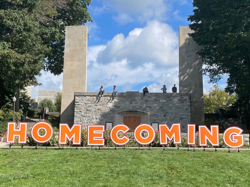 Homecoming sign in big letters against the backdrop of War Memorial Chapel.