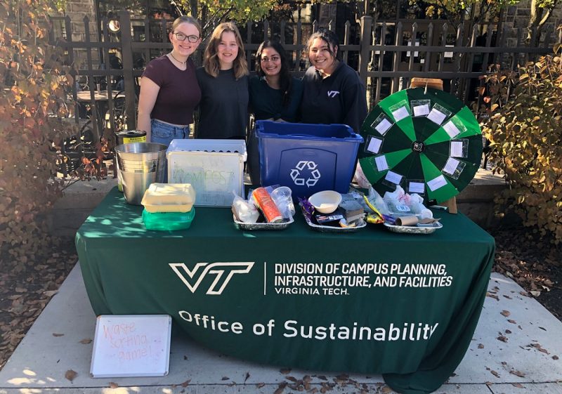 Four sustainability interns pose at awareness event around recycling