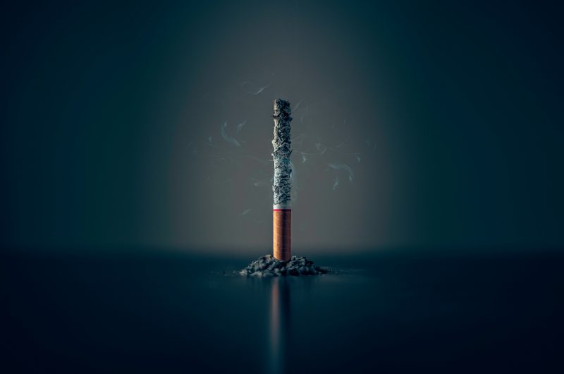 A cigarette slowly burns. 