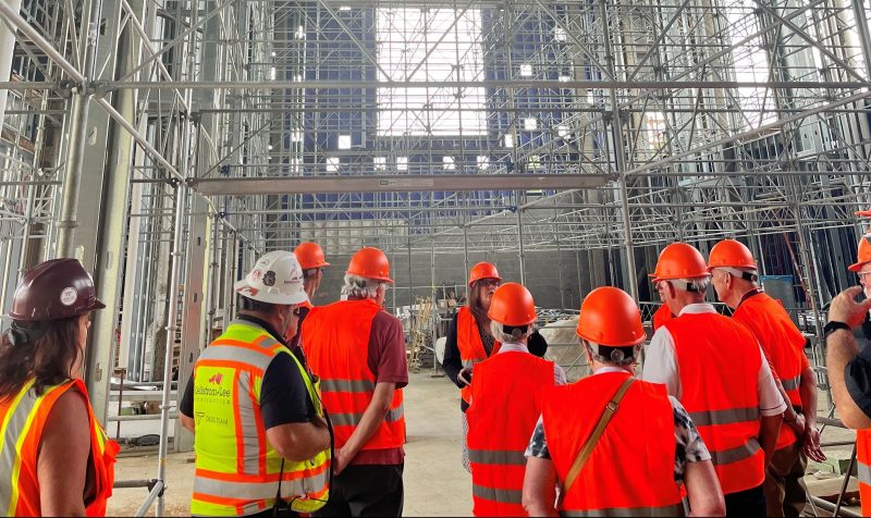 Tour attendees within great room with extensive scaffolding within the Data & Decision Sciences Building