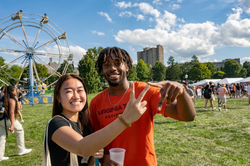 Students make the VT symbol while enjoying Gobblerfest on Sept. 2