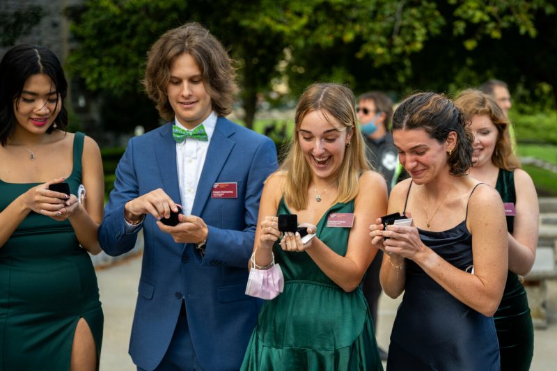 students looking at their rings