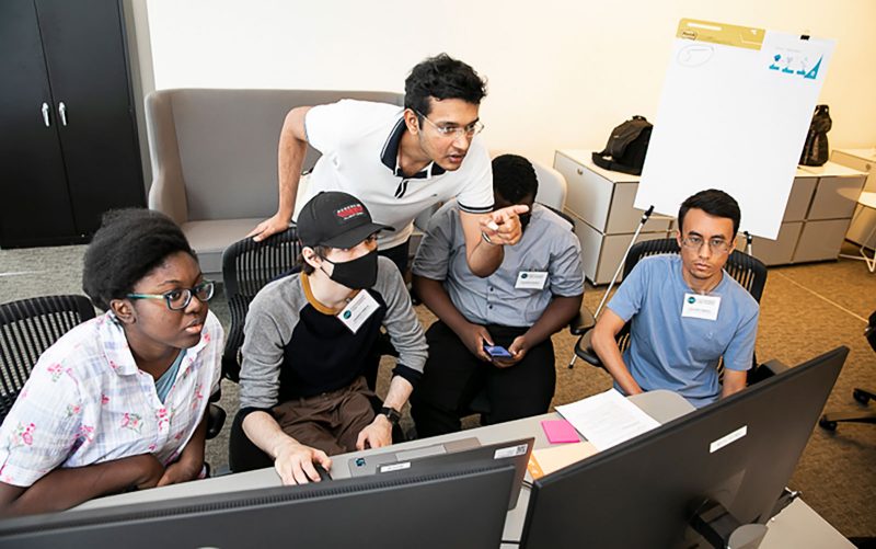 Students at the Commonwealth Cyber Initiative (CCI) 2022 Cyber Camp work to solve a team challenge. 