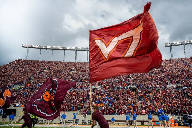 Virginia Tech flag in front of full stadium 