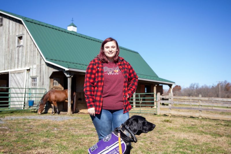 Devin Wynne is able to participate in the horse lab because of her service dog, Gideon. Photo by Max Esterhuizen for Virginia Tech.