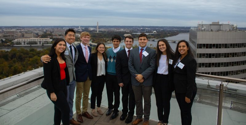 Real Estate Students Pose in Arlington on a rooftop against a DC backdrop