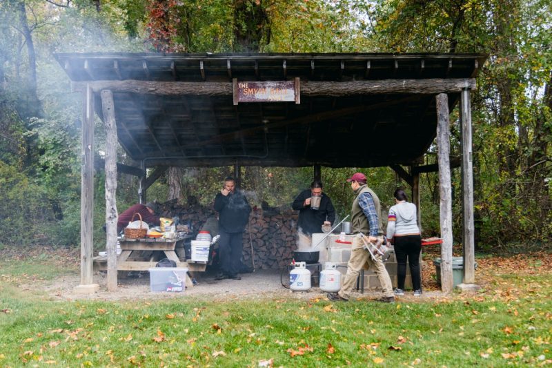 Smoke wafts from an outdoor kitchen near the Indigenous Friendship Garden, where chefs are preparing soups to feed to community members.