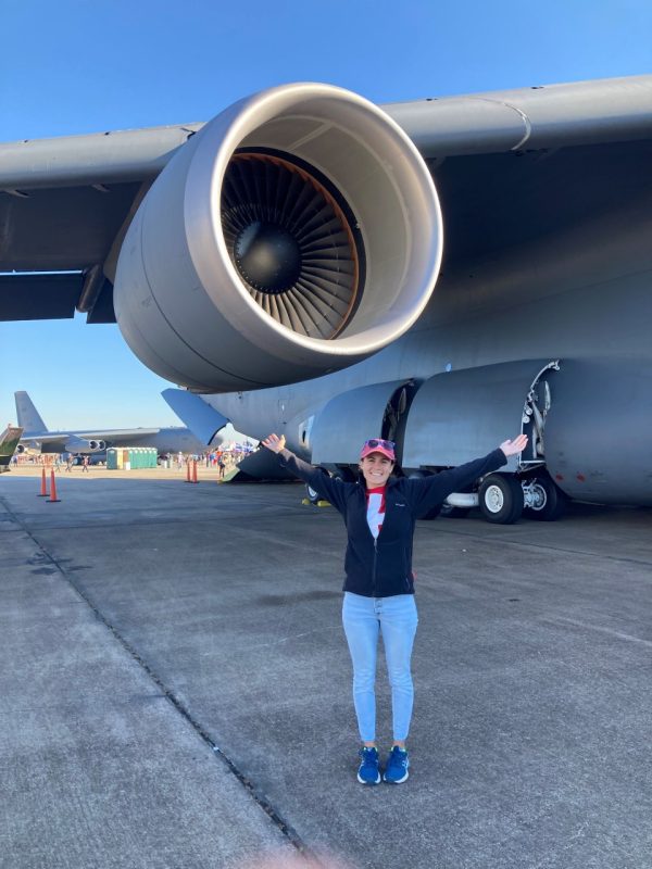 Woman standing in front of a jet engine