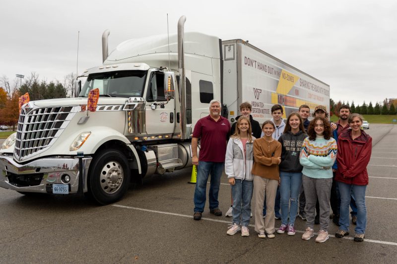 Students and Sharing the Road team in front of the VTTI truck at Blacksburg High School