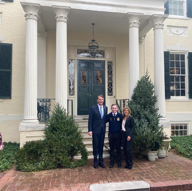Andrew Seibel (at center) stands with Virginia Gov. Glenn Youngkin and First Lady Suzanne Youngkin on the steps of the Executive Mansion in Richmond, Virginia.