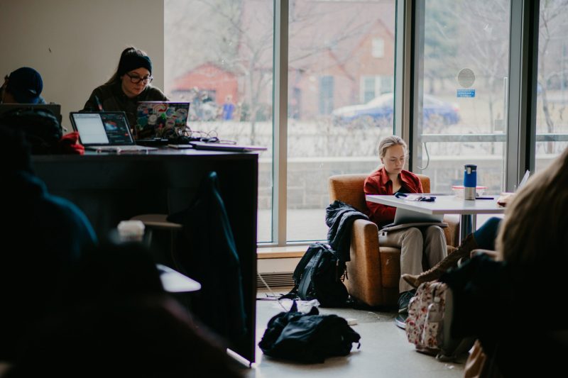 Three students study in Goodwin Hall.