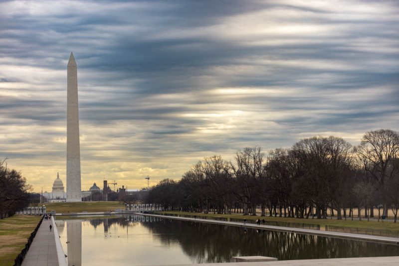 Image of Washington Monument with Capitol in background against cloudy skies