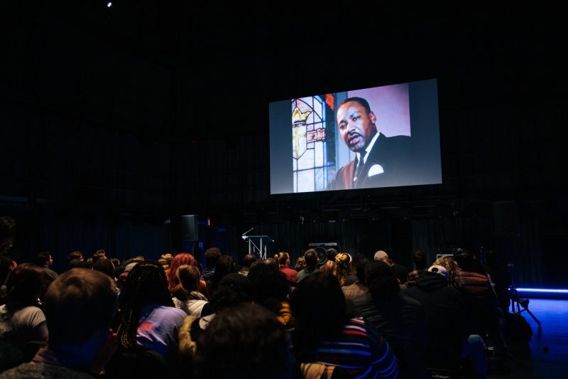 Image of Martin Luther King Jr. projected onto a wall for an event in his honor