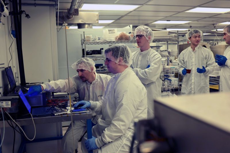 Weeks away from delivery, students and faculty work on their satelitte in a clean room at Space@VT.