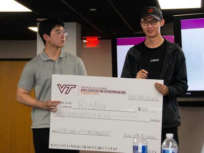 Two students holding a large check