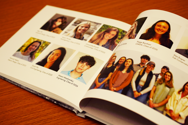 A picture of an open book with pages displaying author photos.