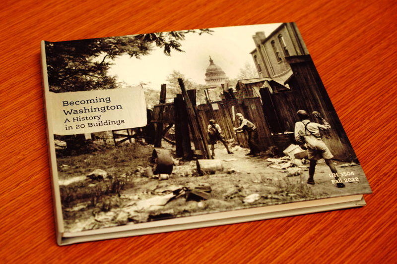 A book cover with a greyscale picture of an old Washington D.C. neighborhood and the text "Becoming Washington: a History in 20 Buildings"