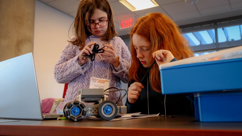 two students building a robot