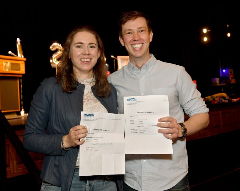 Two VTCSOM students hold their match letters for their couples match.