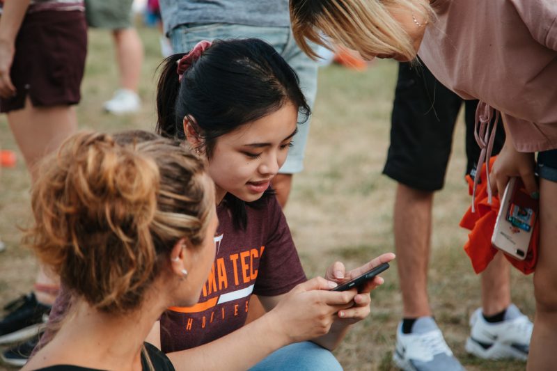 Photo of student surfing social media on her phone