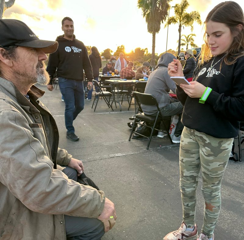 Child helping at We See You San Diego dinner