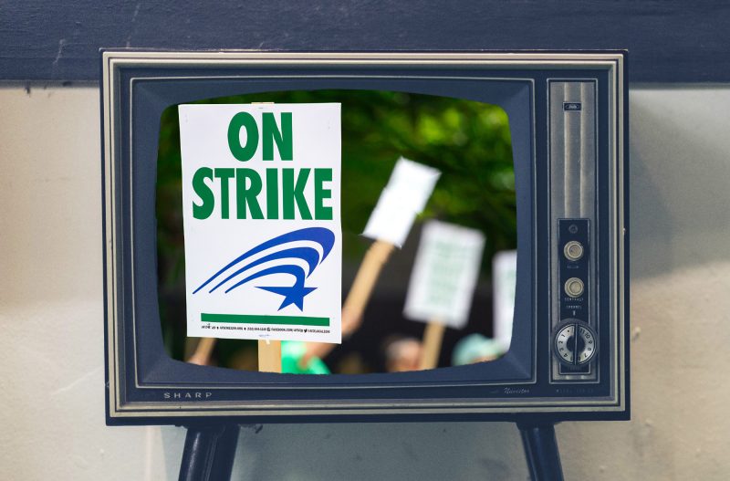 A television screen showing signs from a labor strike. Image courtesy Pexels/Pixabay.