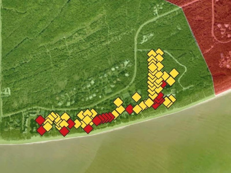 A satellite map of a section of beach on the island. The map is covered with red and yellow icons which indicate buildings that have been evaluated by the volunteers.