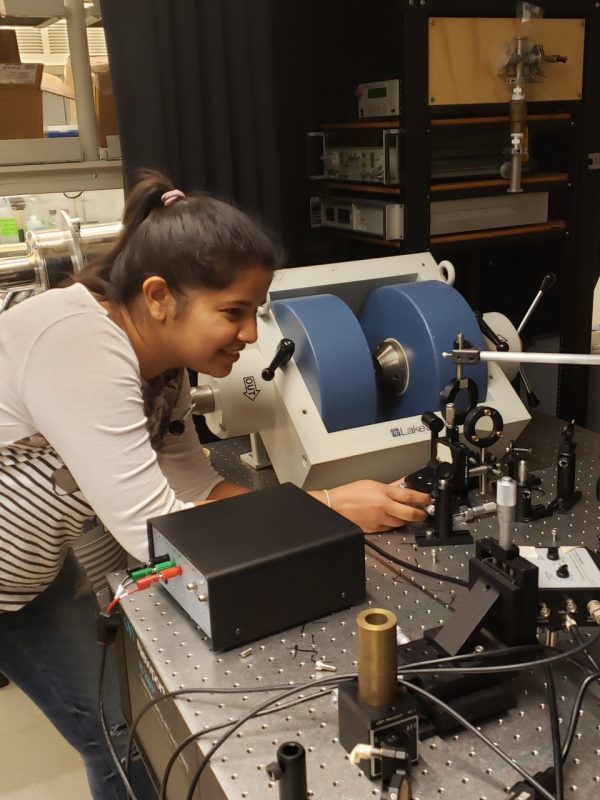 graduate student works on equipment in a lab 