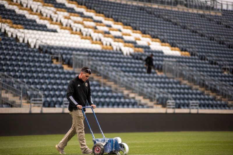 Buck helping prep the stadium for match day. Photo courtesy of Buck.