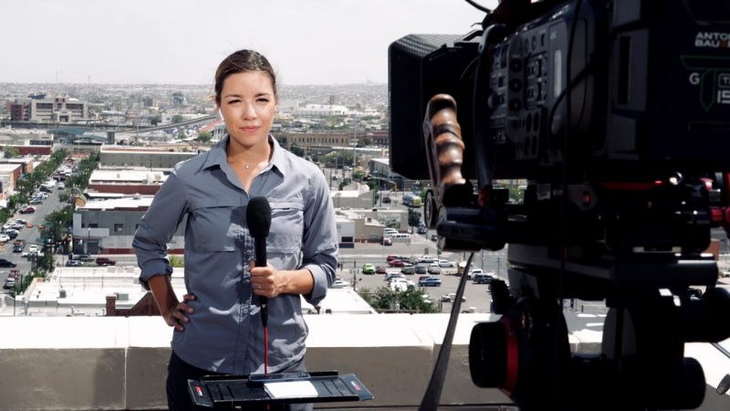 CNN reporter and Virginia Tech alumnus Priscilla Alvarez holds a microphone in one hand while speaking into a camera.