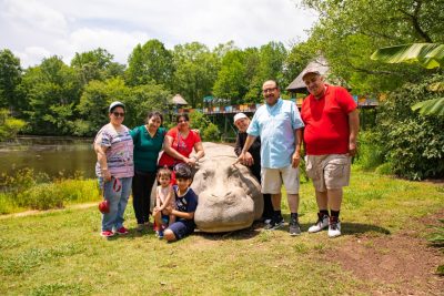 Dining staff posing in front of a hippo statue at the North Carolina Zoo. Photo by Darren Van Dyke for Virginia Tech Dining Services.