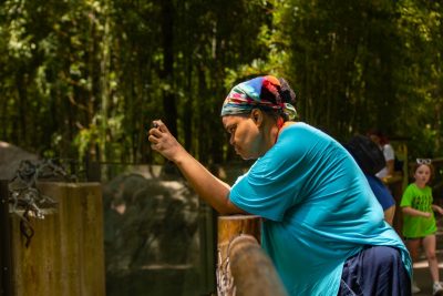 Dining employee taking a picture of an animal at the North Carolina Zoo. Photo by Darren Van Dyke for Virginia Tech Dining Services.