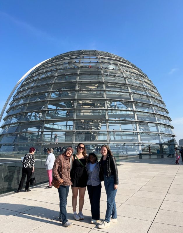 Female engineering students stand outside of glass building in Germany 