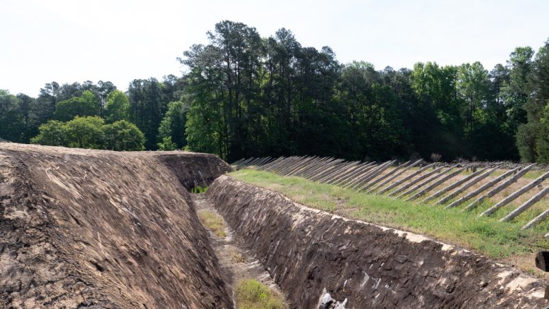 Photo shows Pamplin Historical Park trenches and large wooden spikes in front of them.