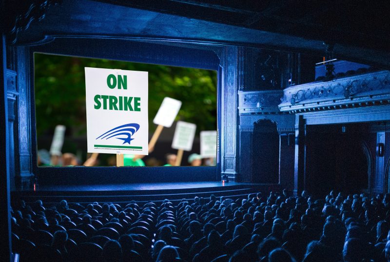 Movie theater with a strike sign on screen. Image courtesy Pexels.