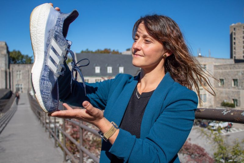 Jennifer Russell holds an Adidas tennis shoe.