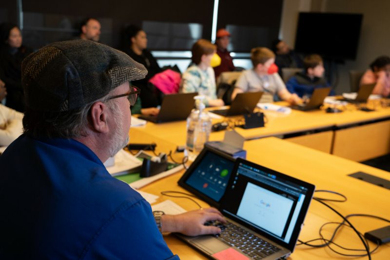 Thomas Weeks leads a computer coding class for children. 