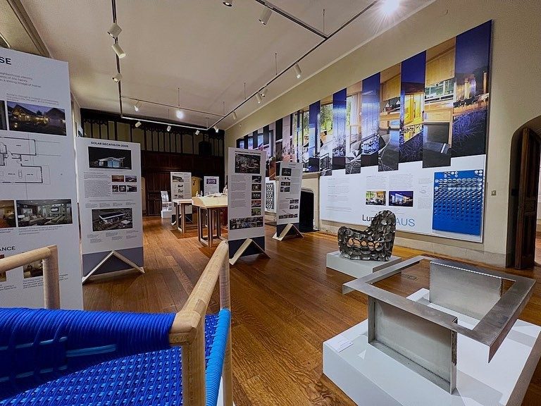 A view of the gallery at the Branch Museum featuring large murals, free-standing panels, models, and furniture.