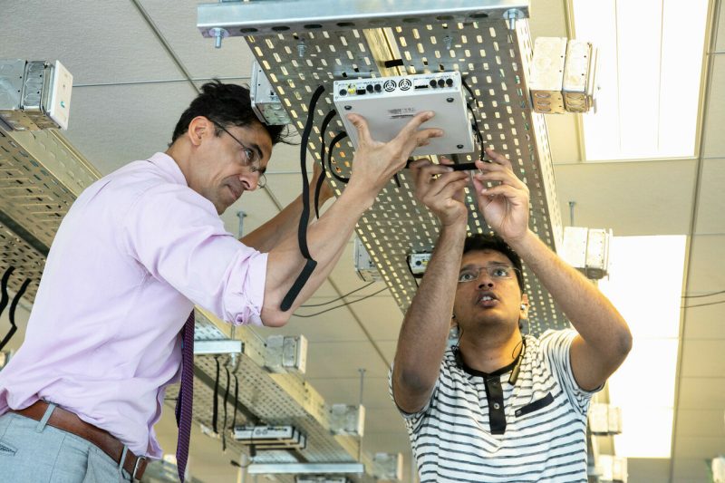 CCI xG Testbed Director Aloizio P. DaSilva (left) builds the testbed with help from graduate student Vikas Radhakrishnan