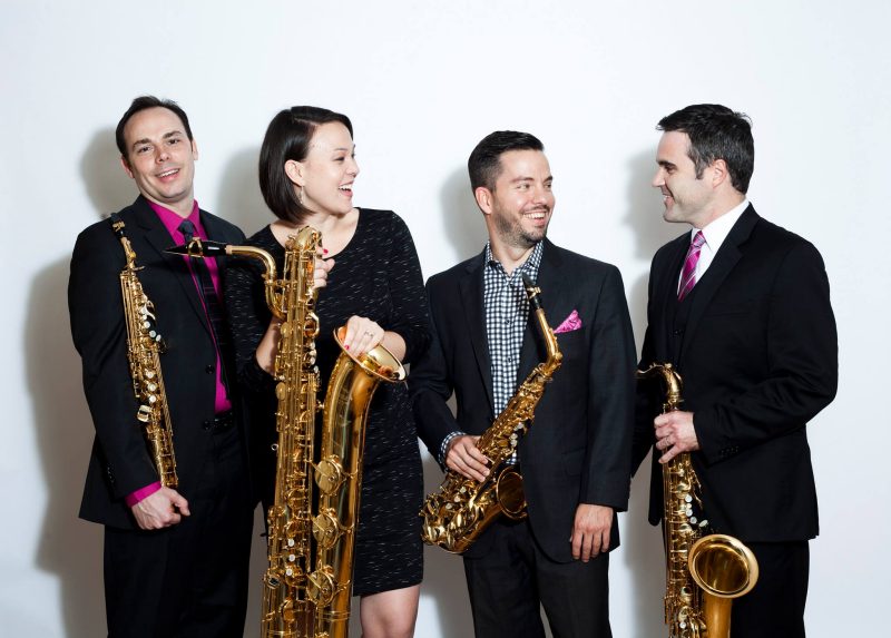 The h2 quartet pictured, from left to right:  Jeffrey Loeffert, Kimberly Goddard Loeffert, Geoffrey Deibel, and Jonathan Nichol. Each member is holding a saxophone.