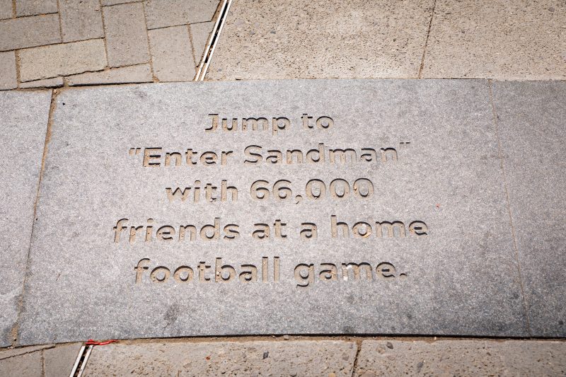 Paving stone on Quillen Spirit Plaza engraved with Enter Sandman tradition text. 