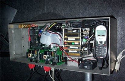 A data acquisition system (DAS) installed in the trunk of a vehicle.