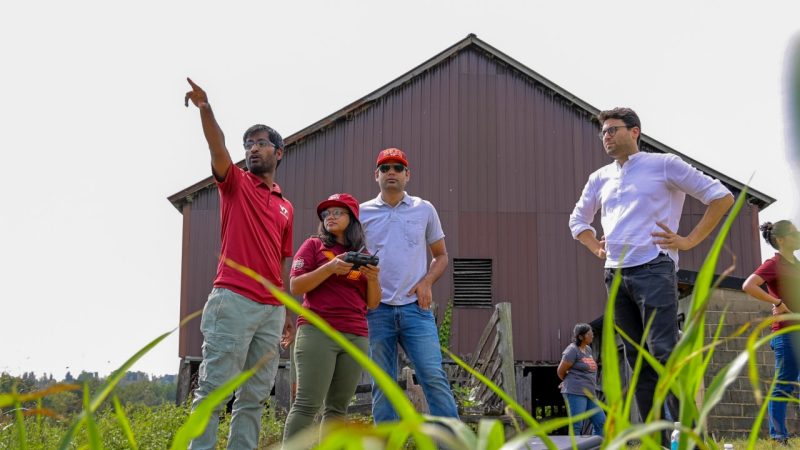 Maaz Gardezi (at right) works with a research team at a farm in Bedford, Virginia, as part of his smart technology farming grant project. Photo by Luke Hayes for Virginia Tech.