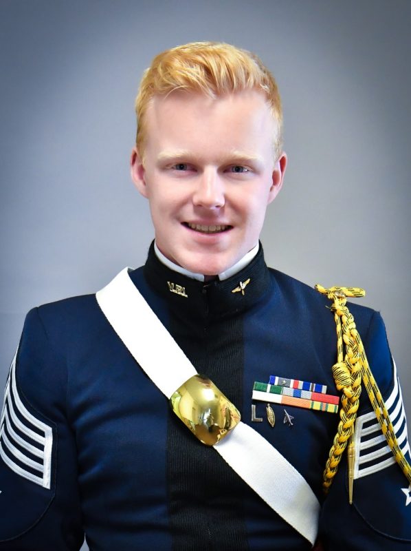 Portrait of Cadet Sosnowski. His uniform blouse is blue and he is wearing a white crossbelt with a brass breastplate.